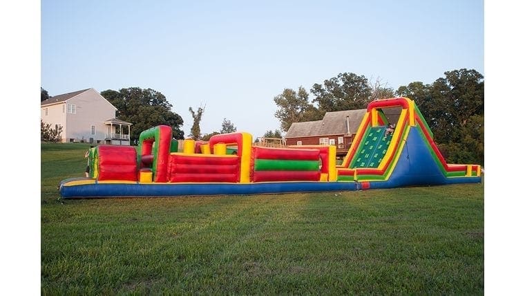 Large outdoor inflatable obstacle course at fun outdoor event