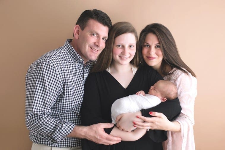 newborn baby photo with parents and sister
