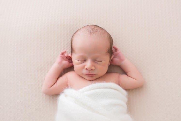 newborn baby photo in natural swaddling