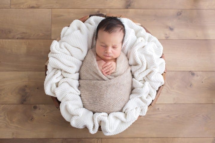 newborn baby photo fully swaddled in a prop