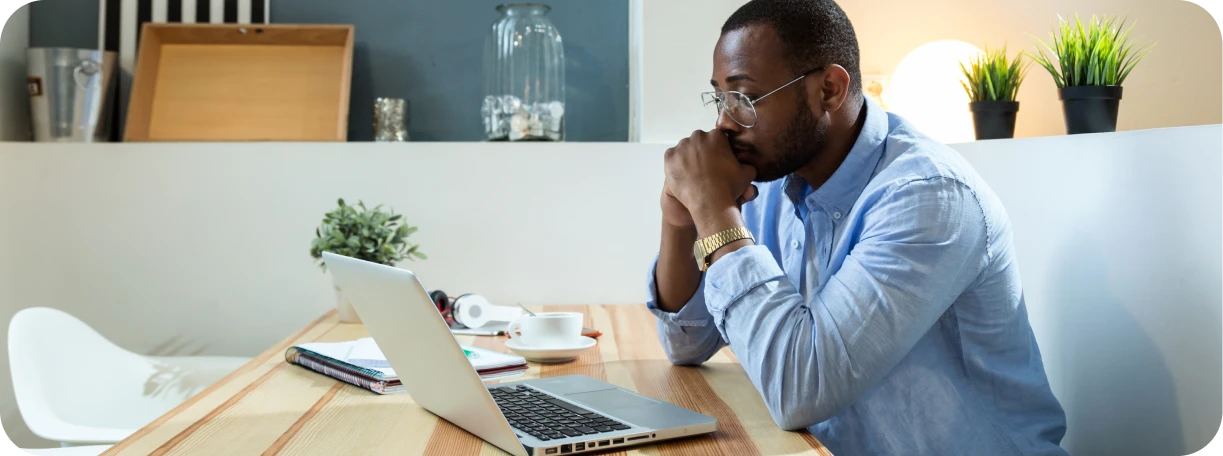 Client struggling with researching different insurance options online with multiple tabs and paperwork 