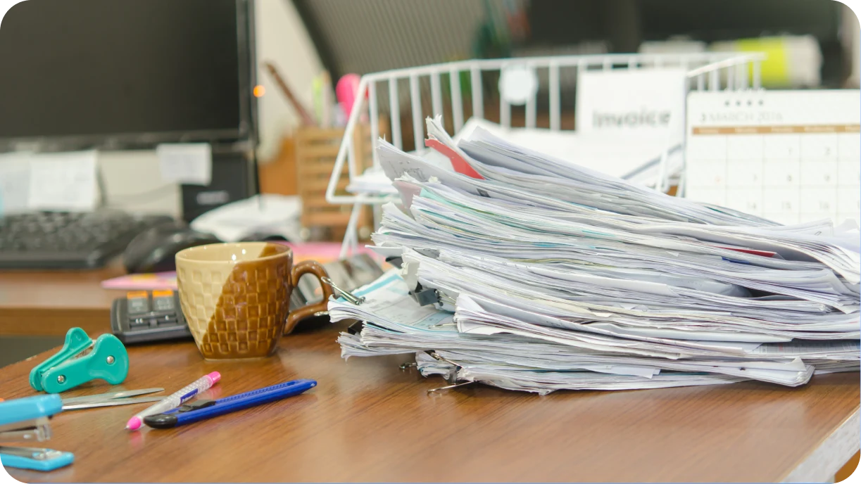 Messy stack of handwritten pull sheets and printed maps representing outdated delivery planning methods.