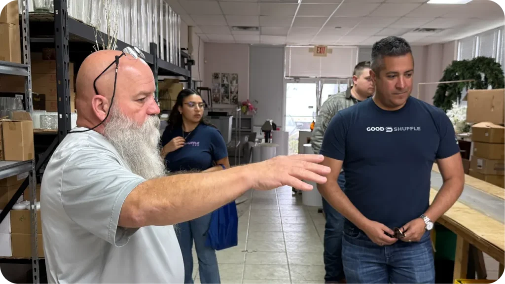 Goodshuffle Pro team discussing operations with event rental business owner during warehouse tour