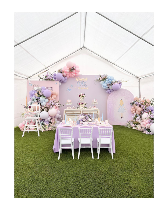 Lavender linens, chiavari chairs, a dreamy balloon arch, and florals that make a tented backyard feel like a storybook
