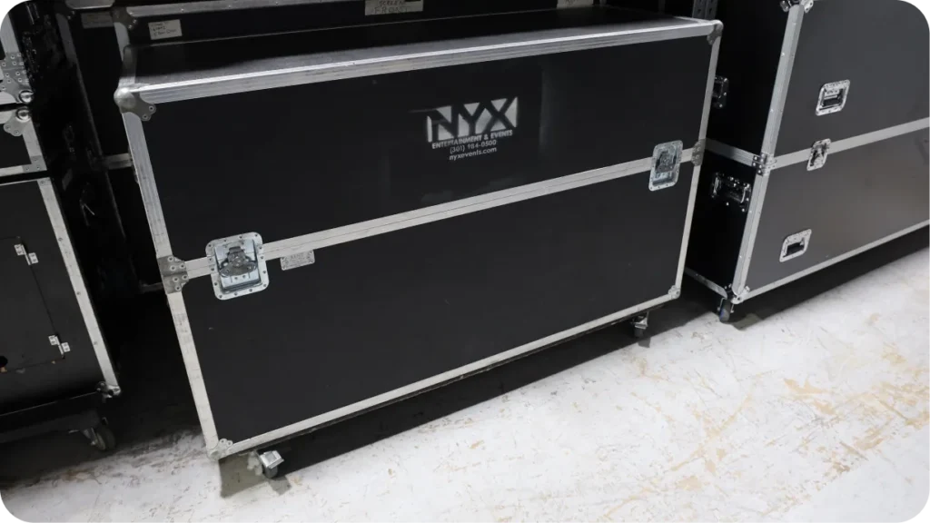 Heavy equipment cases on wheels stored on lower shelving