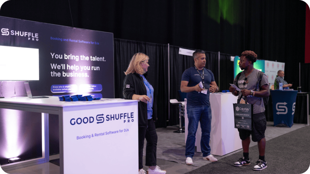 Goodshuffle Pro team members talking with an attendee at the company's booth at DJX 2026 in Atlantic City