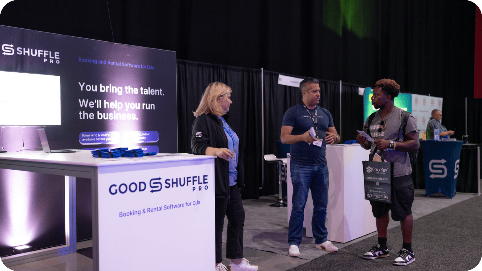 Goodshuffle Pro team members talking with an attendee at the company's booth at DJX 2026 in Atlantic City