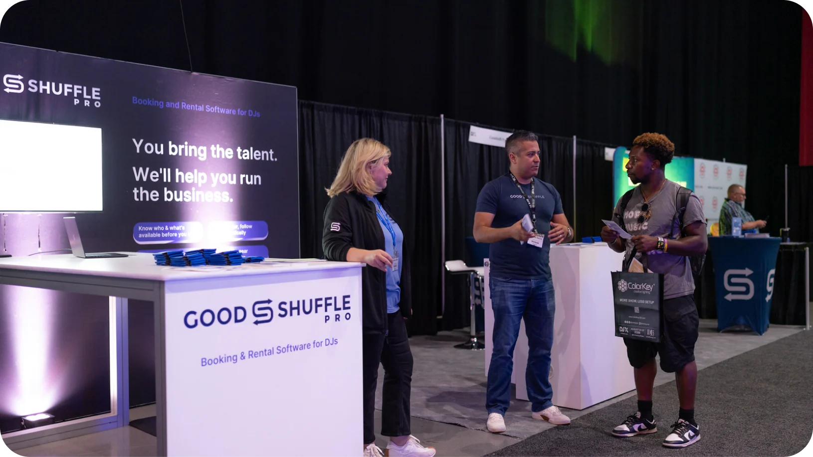 Goodshuffle Pro team members talking with an attendee at the company's booth at DJX 2026 in Atlantic City