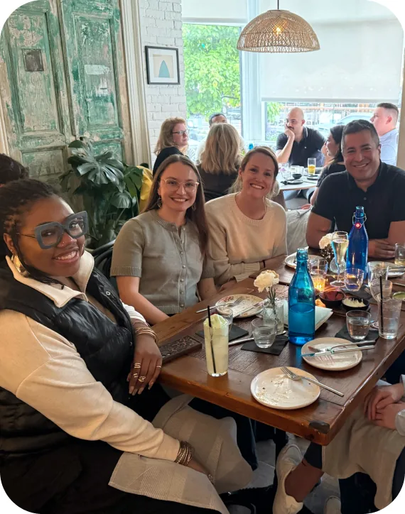 Goodshuffle teammates smiling around a restaurant table