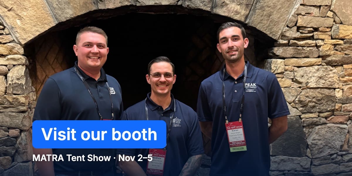 Marshall with two tent pros at The Tent Show, with a Visit our booth label